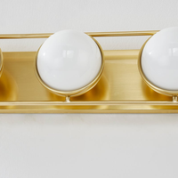 Lyra Aged Brass Globe Vanity Sconce