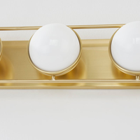 Lyra Aged Brass Globe Vanity Sconce